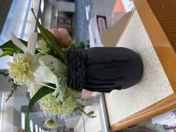 Black painted jar with fake flowers