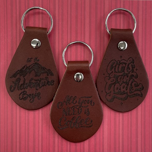 three engraved leather keychains