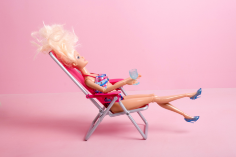 Barbie sitting in a beach chair